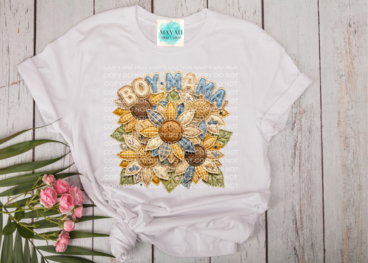 White t-shirt with a colorful sunflower design and text on a wooden surface with flowers.