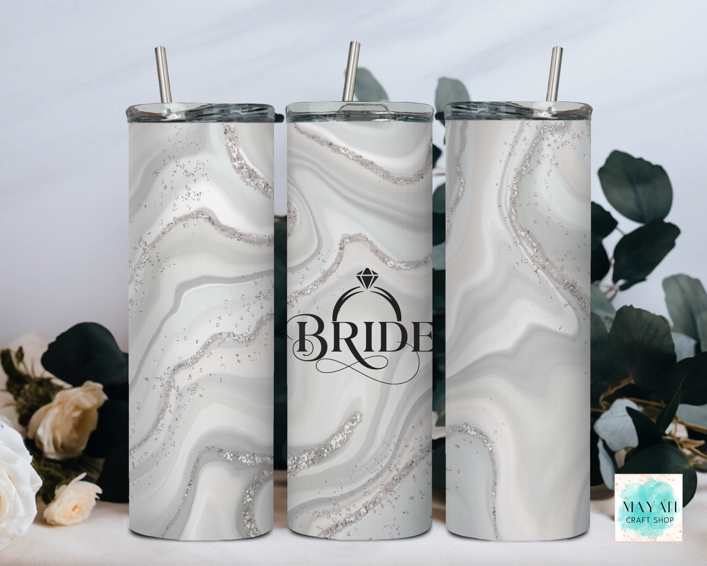 Three marbled tumblers with 'Bride' design on a light background