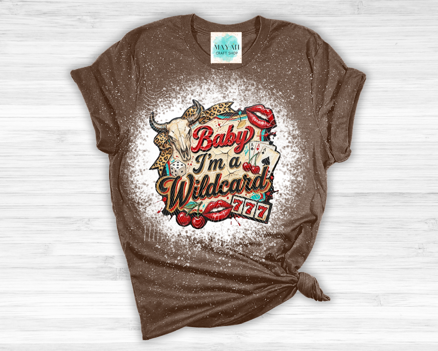 Brown t-shirt with graphic design and text on a wooden surface