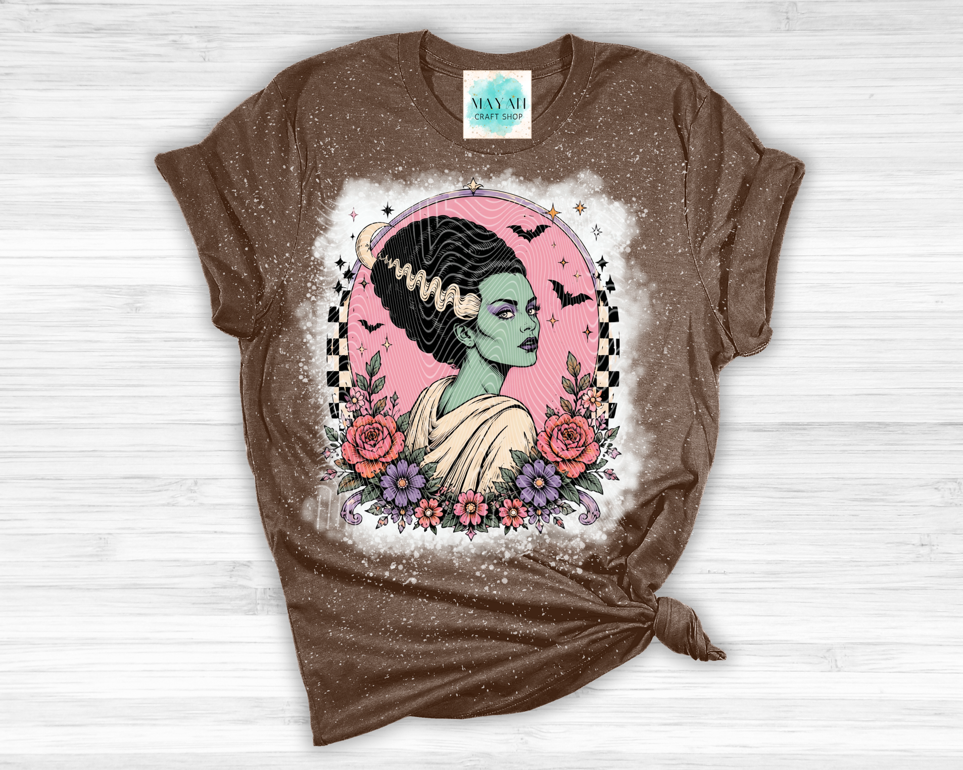 Brown t-shirt with a graphic design of a woman with flowers on a white background