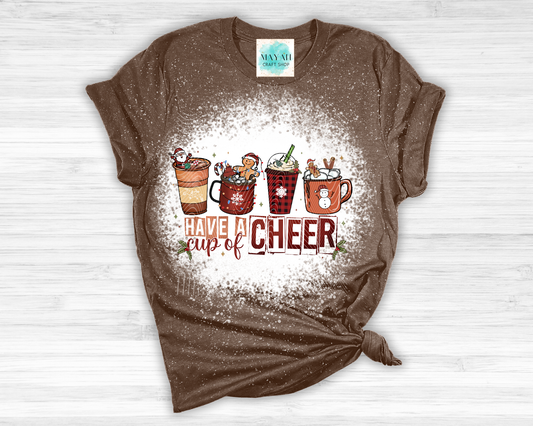 Brown t-shirt with Christmas-themed design on a white wooden surface