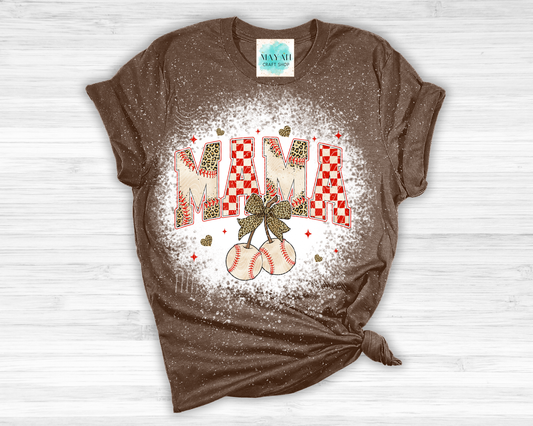 Brown t-shirt with 'MAMA' graphic design on a white wooden surface