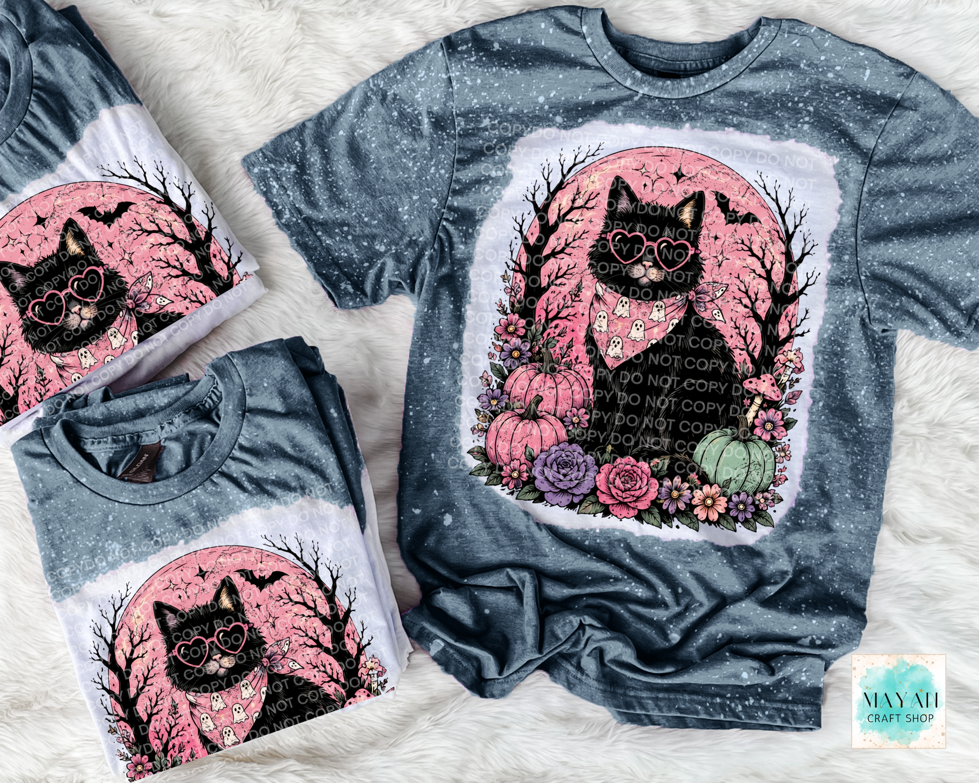 Bleached gray t-shirt with a black cat graphic and text on a white surface