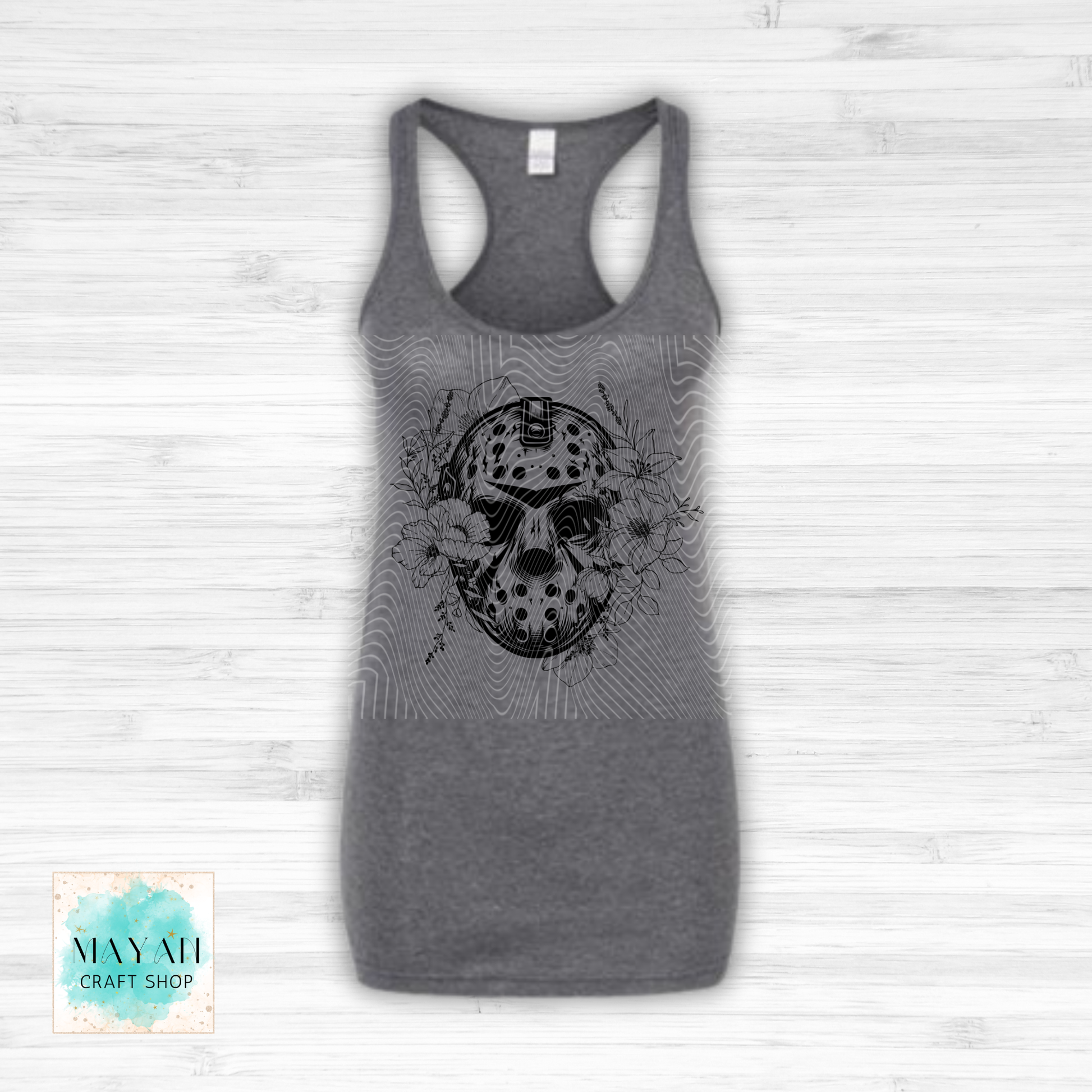 Gray tank top with a black graphic design on a white wooden background