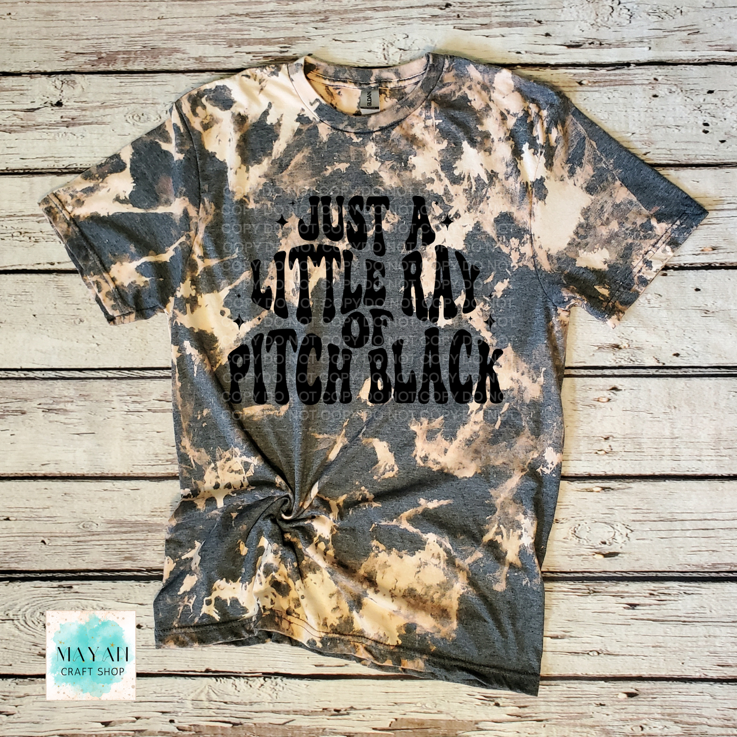 Bleached t-shirt with text on a wooden surface