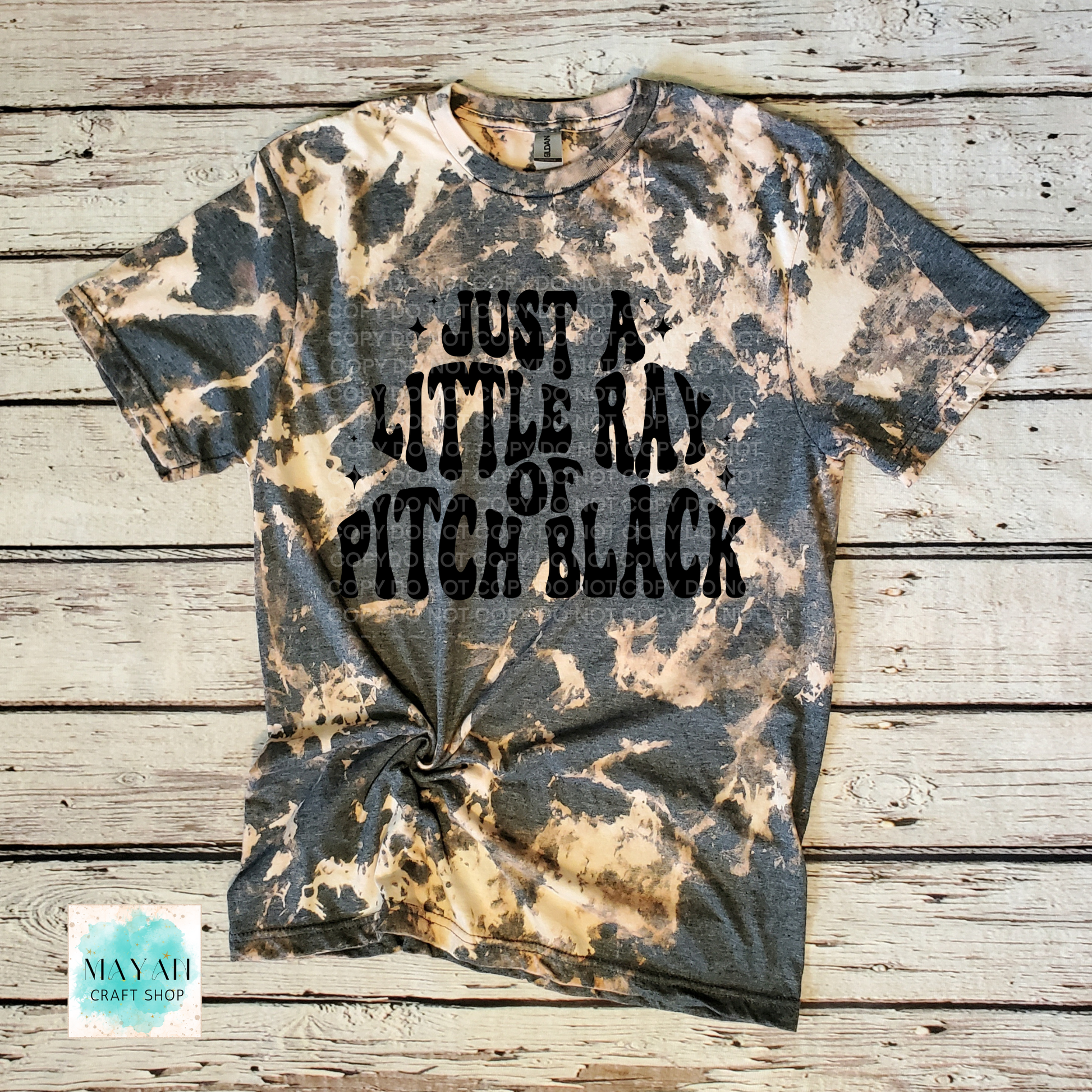 Bleached t-shirt with text on a wooden surface