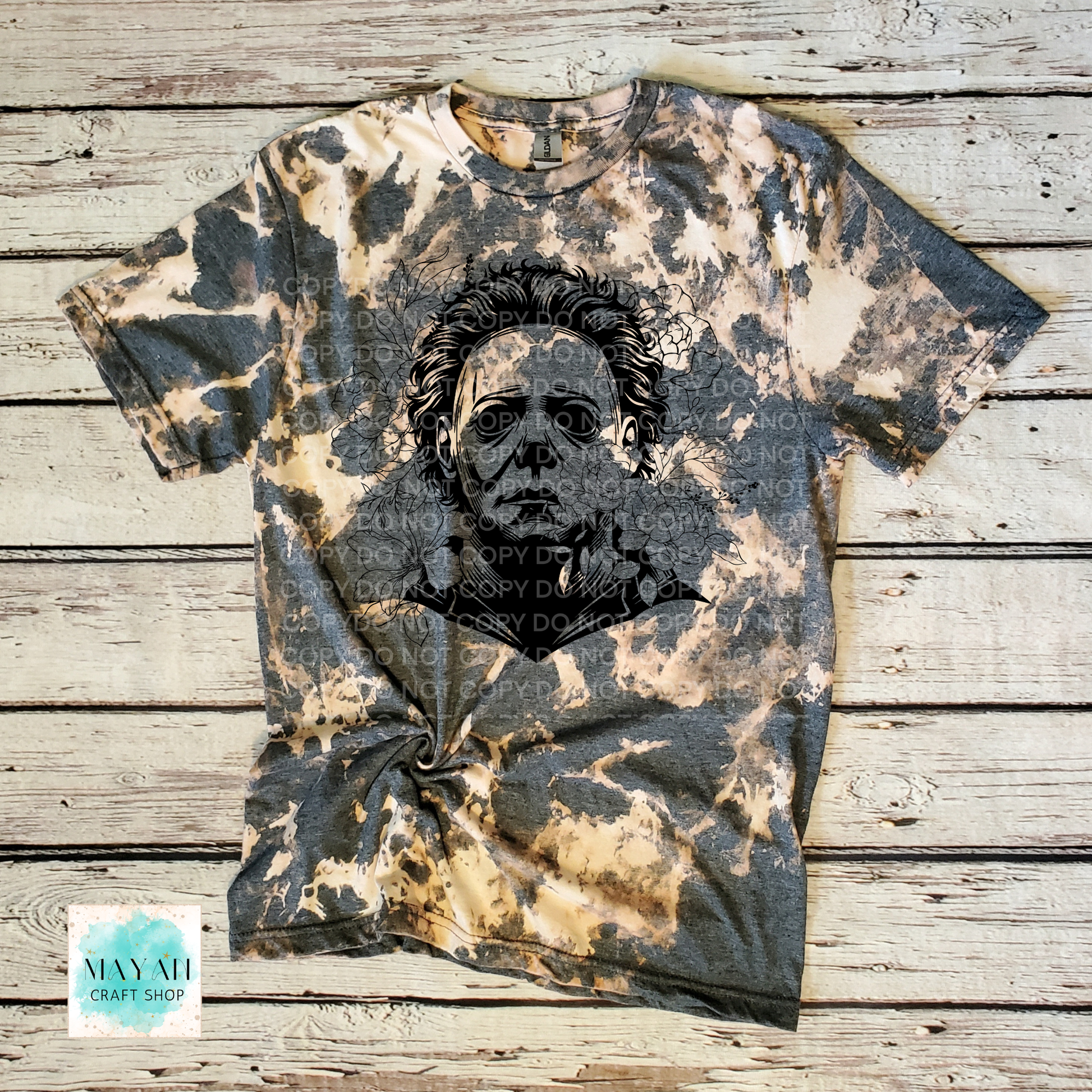 Bleached t-shirt with a graphic design on a wooden surface