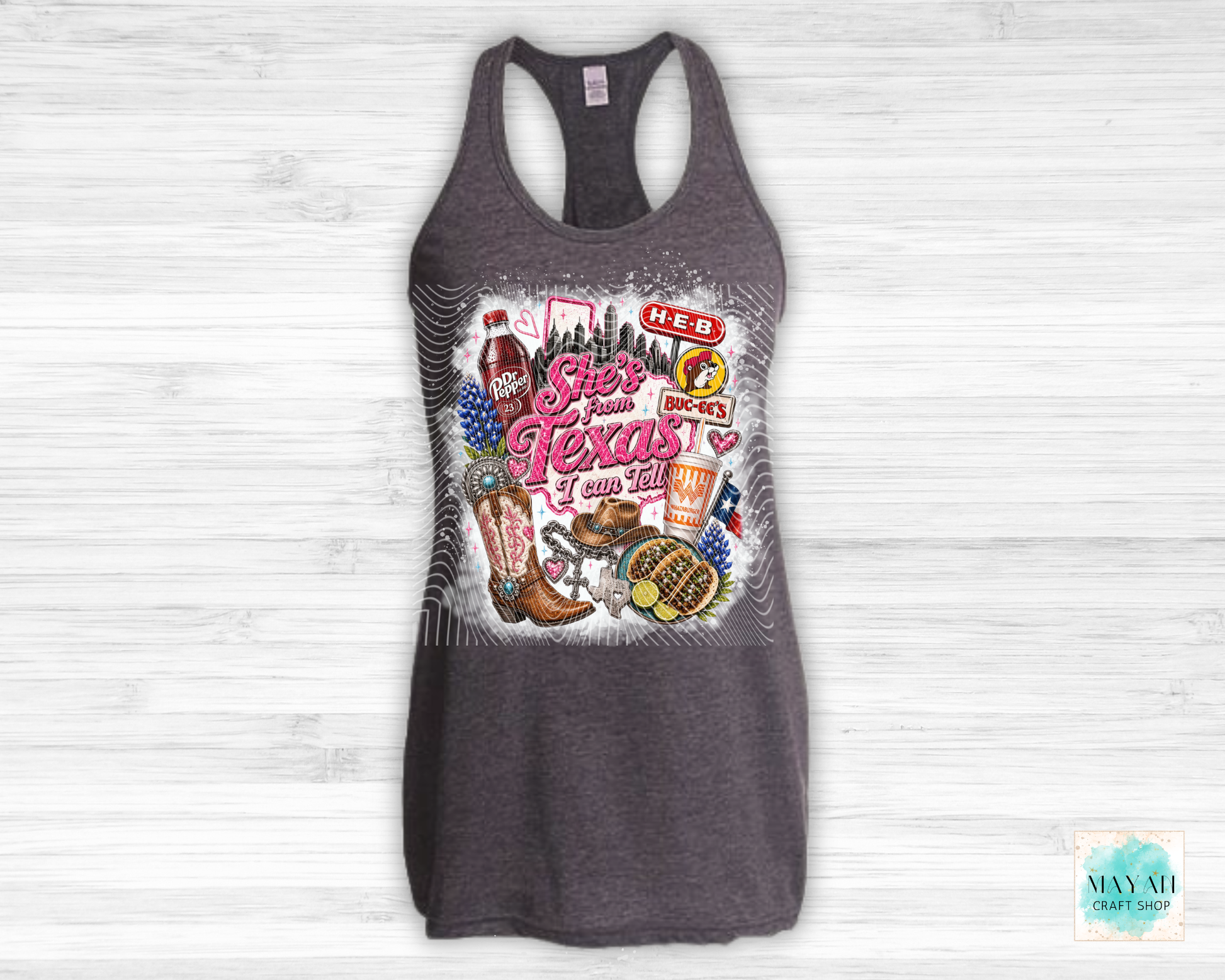 Gray tank top with Texas-themed graphic on a white wooden background