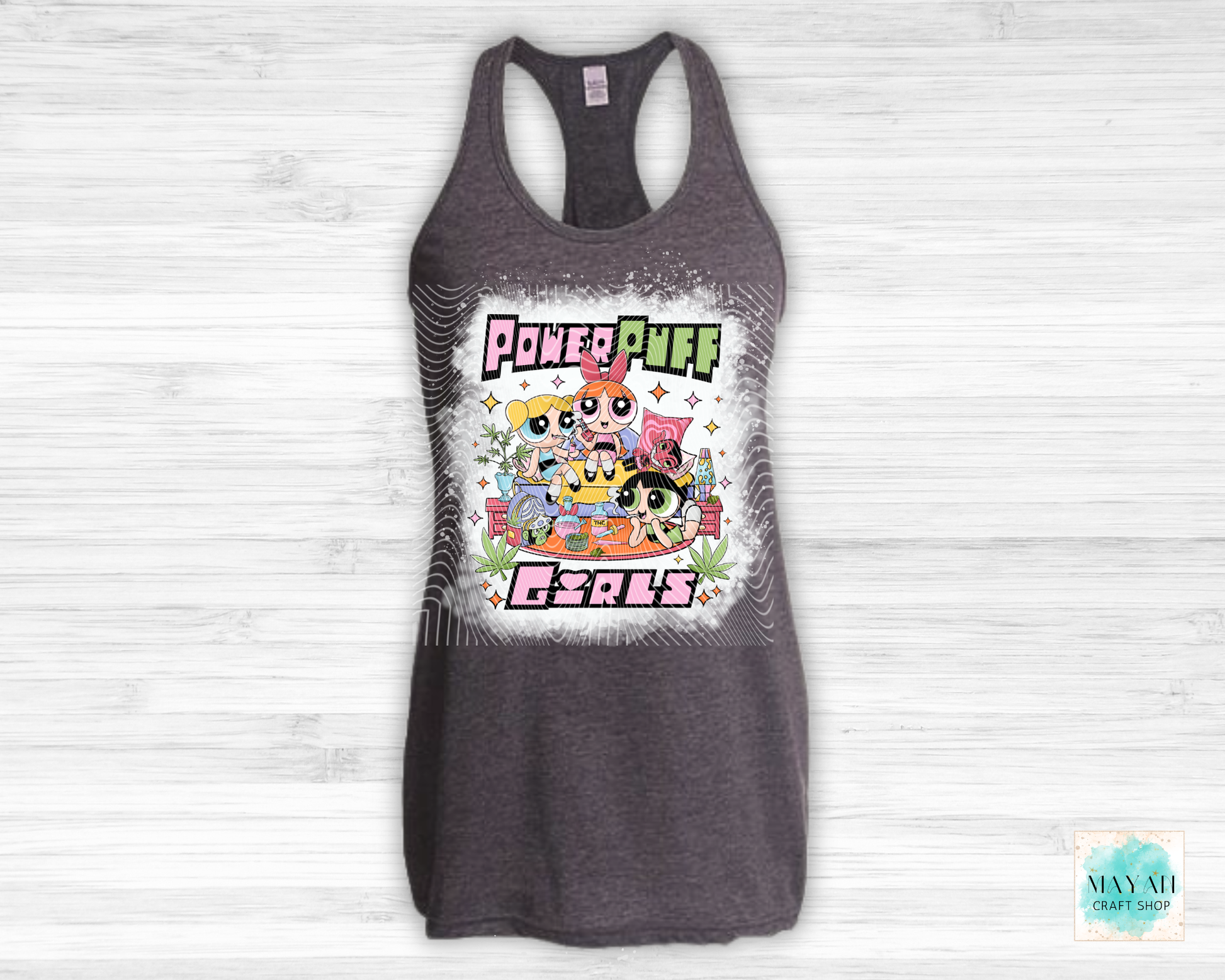 Gray tank top with vibrant graphic on a white wooden background