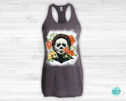 Gray tank top with a graphic design of a face surrounded by flowers on a white background