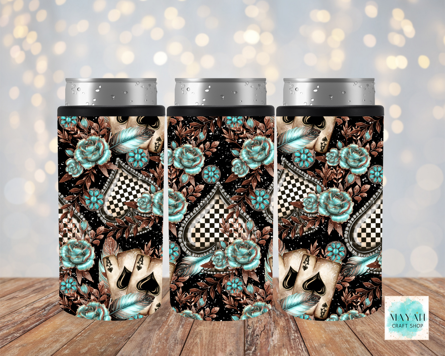 Three tumblers with a decorative design featuring roses and checkered patterns on a wooden surface.