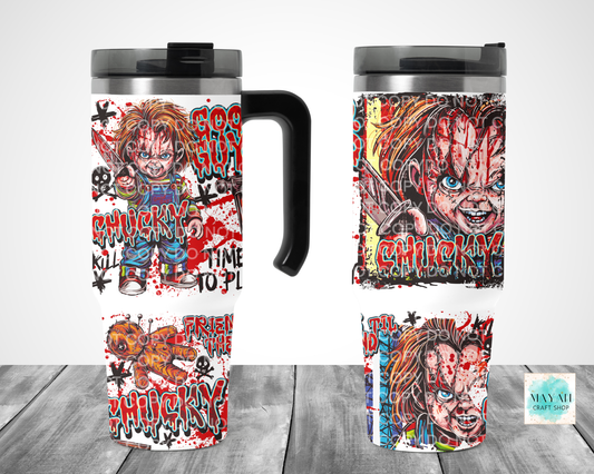 Two views of a travel tumbler mug featuring a horror-themed graphic print, displayed on a gray wood-textured surface against a white background.