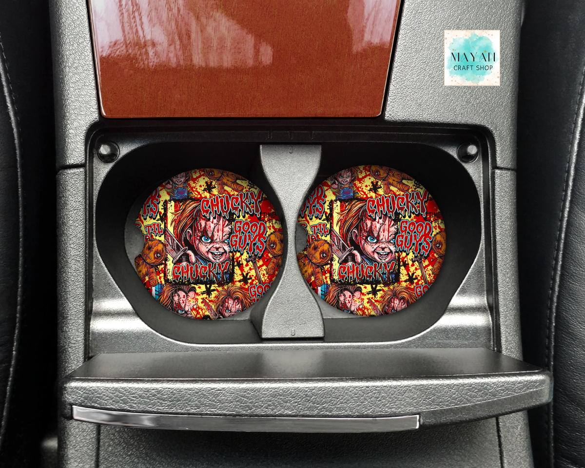 Two circular car cup holders featuring a colorful Halloween design, installed in a car's center console.