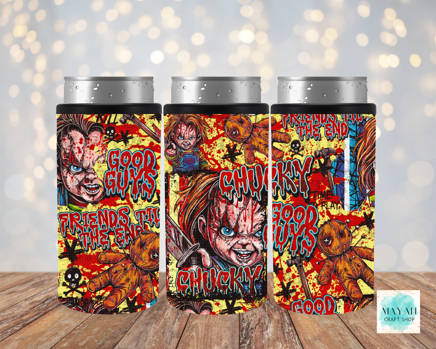 Three slim can coolers featuring a colorful doll, shown on a wooden surface with a soft bokeh light background.