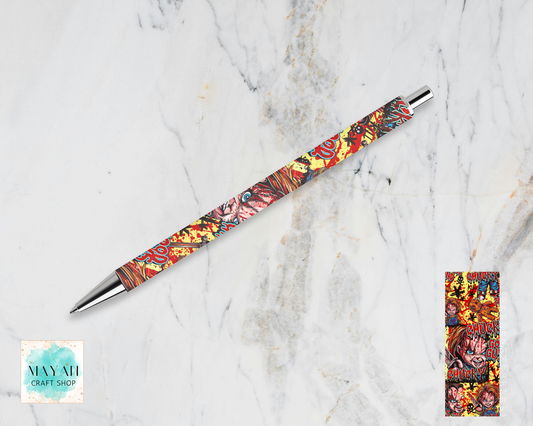 A ballpoint pen with a colorful, detailed illustration pattern on its barrel, displayed diagonally on a white marble background. A close-up of the pattern is shown in a small vertical frame on the bottom-right.