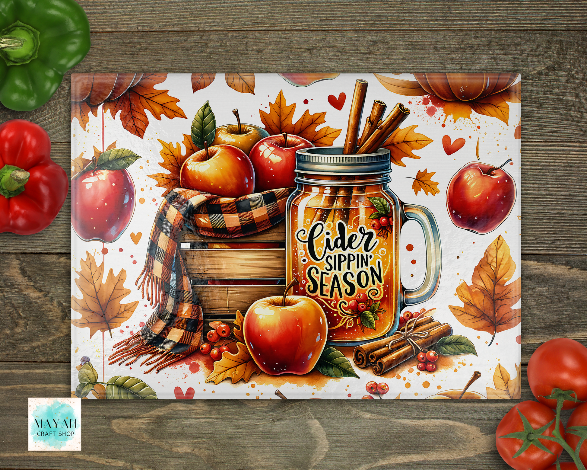 Autumn-themed placemat with apples, pumpkins, and a mug labeled 'Cider Sippin' Season' on a wooden surface.