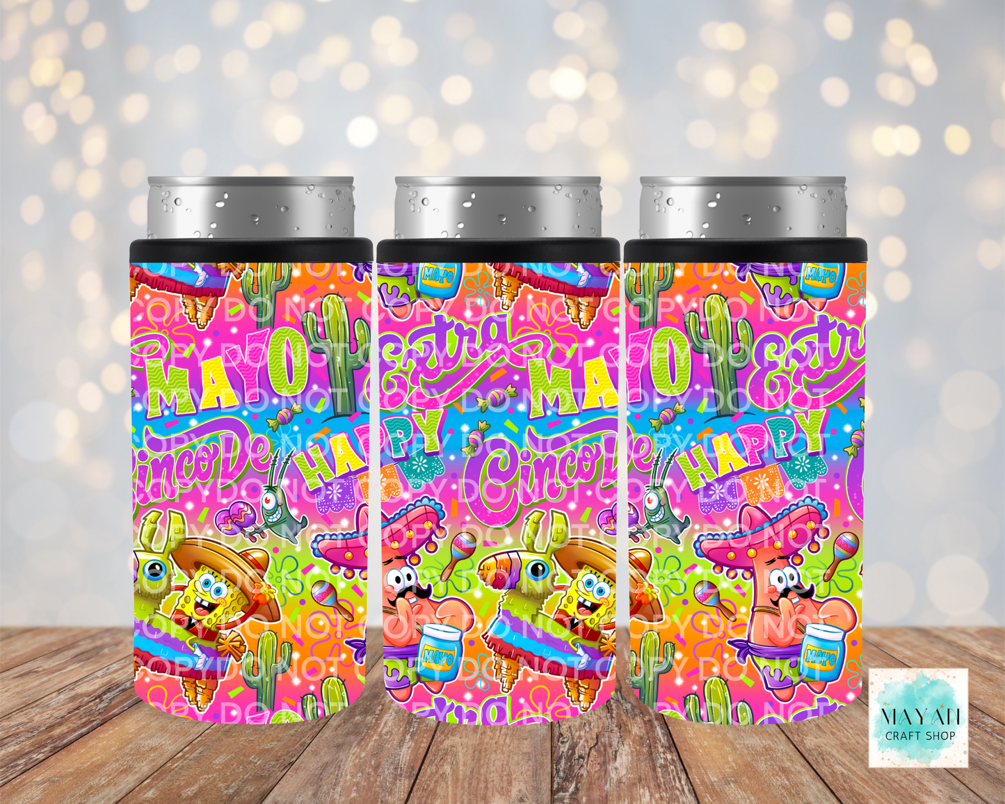Three colorful tumbler designs with cartoon characters on a wooden surface.