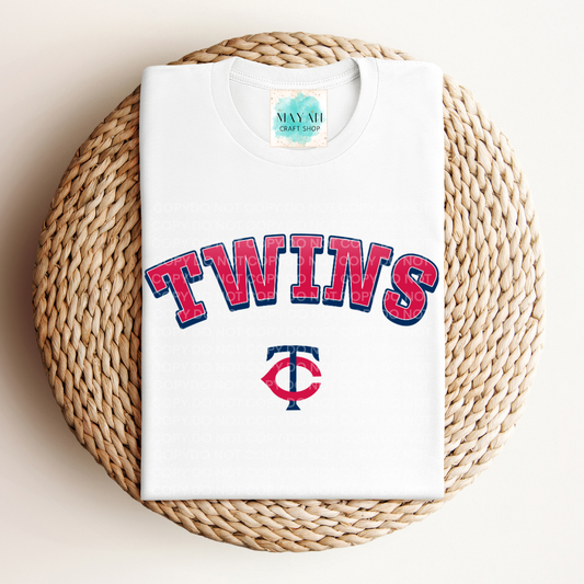 White t-shirt with baseball logo on a woven mat