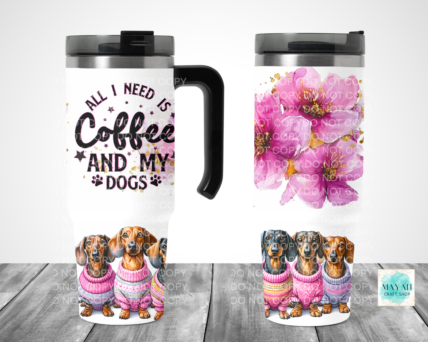 Two travel mugs with different designs on a wooden surface.
