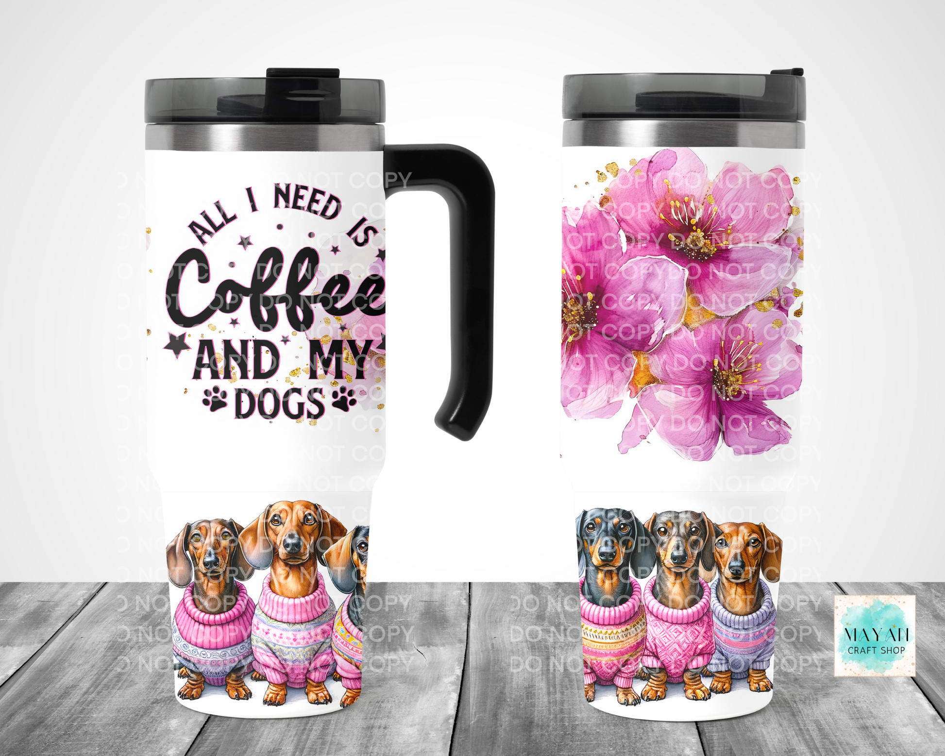 Two travel mugs with different designs on a wooden surface.