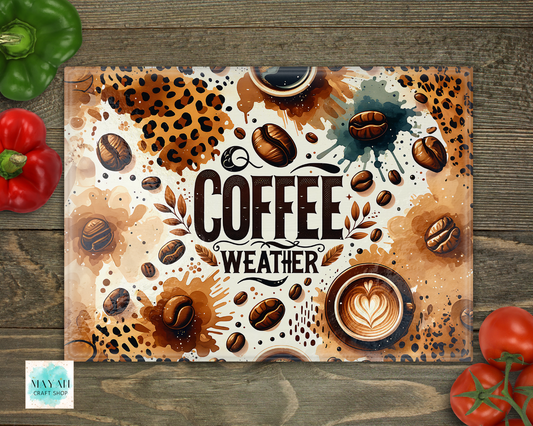 Decorative cutting board with coffee-themed design on a wooden surface