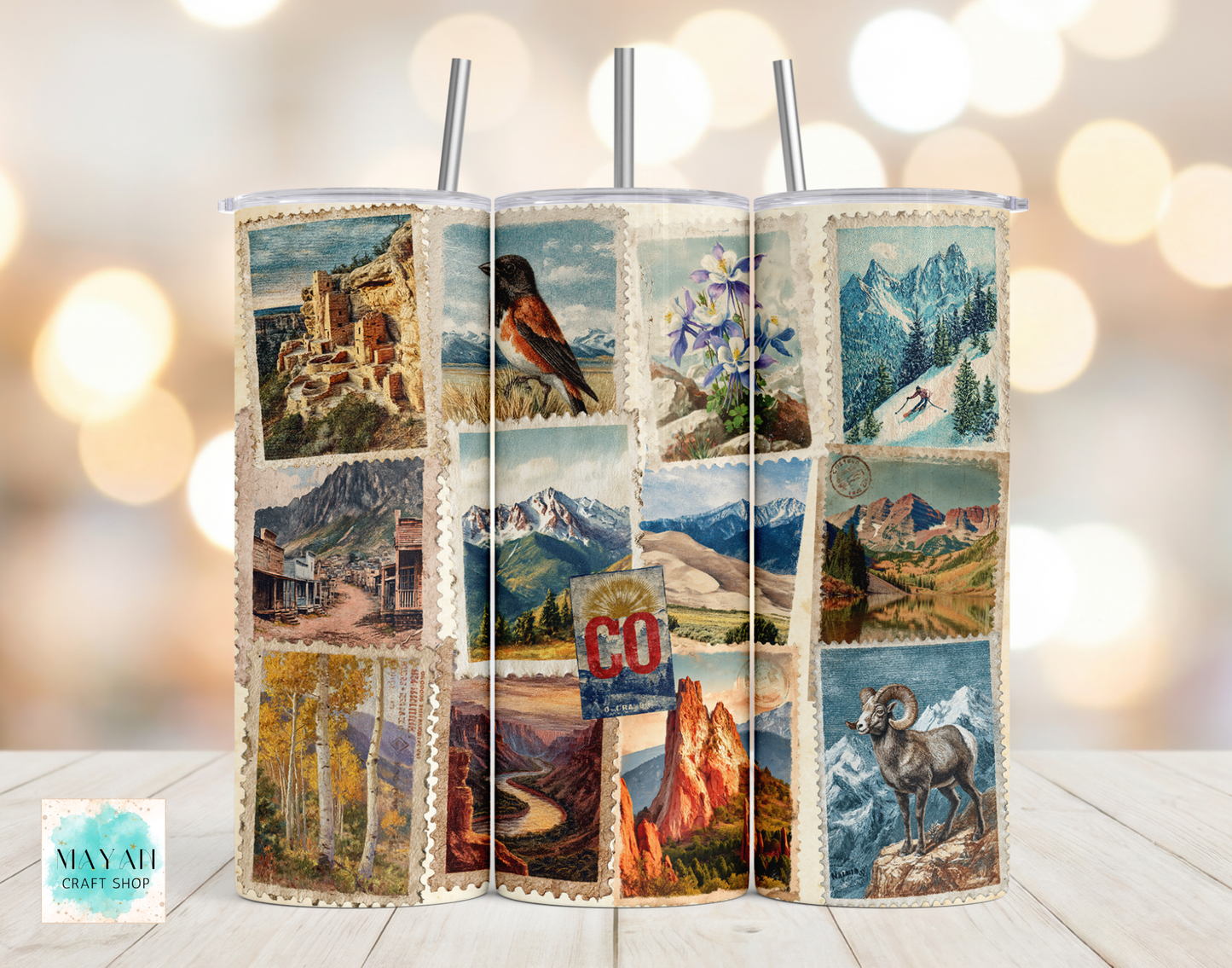 Tumbler with scenic collage design on a wooden surface with blurred lights in the background