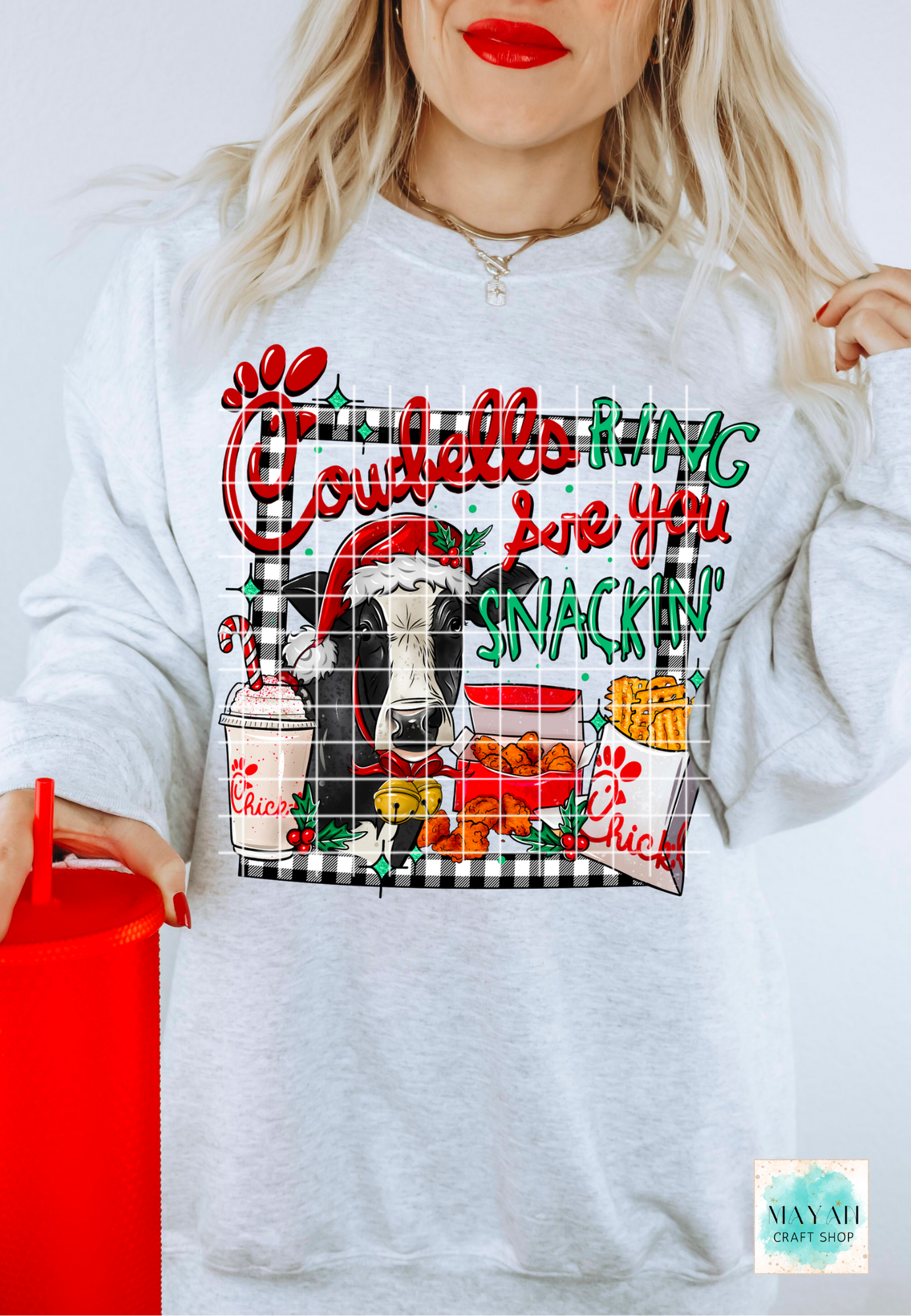 Ash grey sweatshirt with colorful graphic design featuring a cow and text, worn by a person.