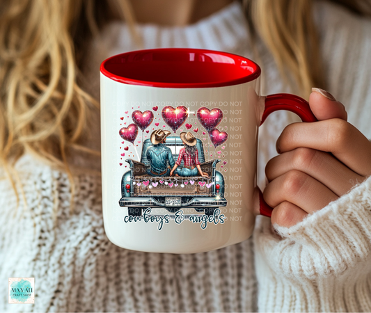 Person holding a mug with a design of cowboys and angels, surrounded by hearts.