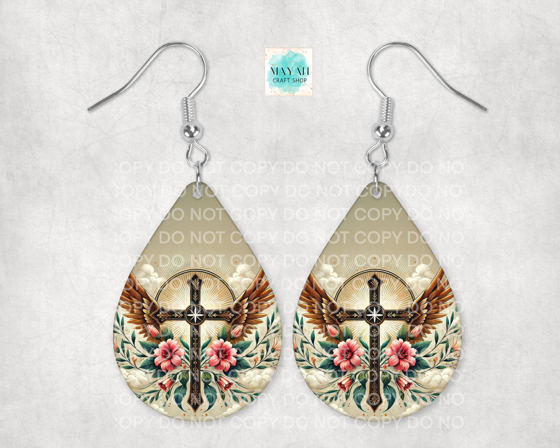 Teardrop-shaped earrings with cross and eagle design on a light background