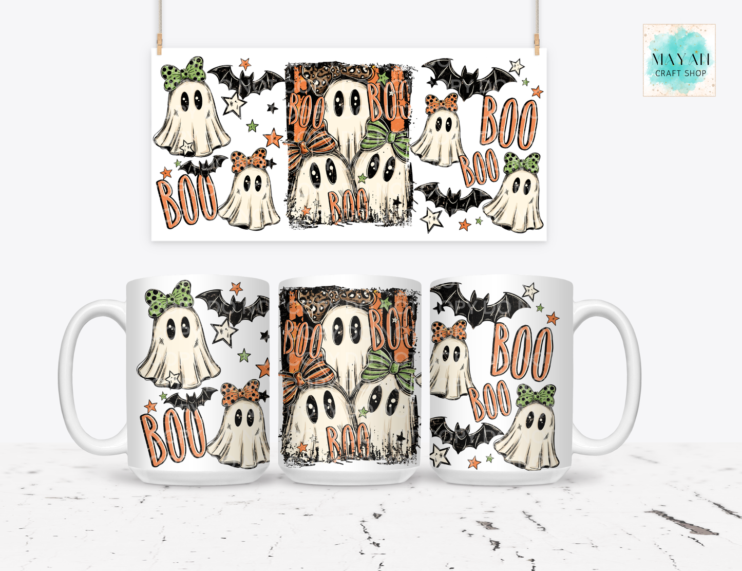 A white ceramic mug shown from multiple angles on a light gray surface, featuring a Halloween ghost illustration with bats, stars, and orange 'BOO' text. Above the mug, a matching rectangular print preview shows the same design.