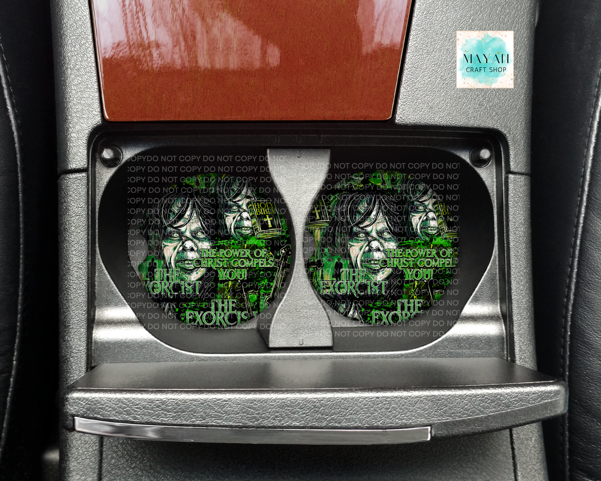 A pair of round car cup holders with a custom printed design featuring a stylized face and a text in green over a black background with repeated 'DO NOT COPY' watermarks. The cup holders are installed in a car console.