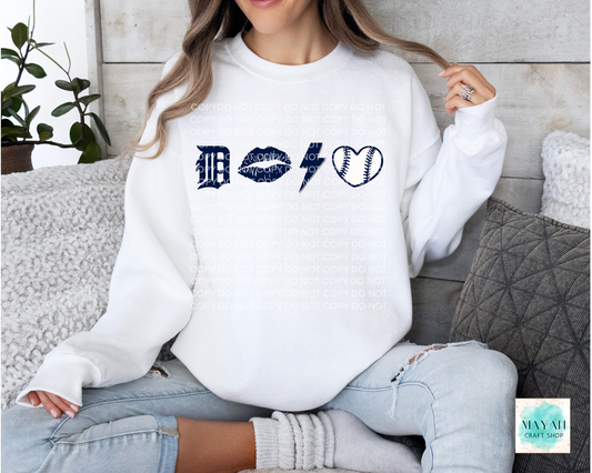 Person wearing a white sweatshirt with graphic designs sitting on a couch.