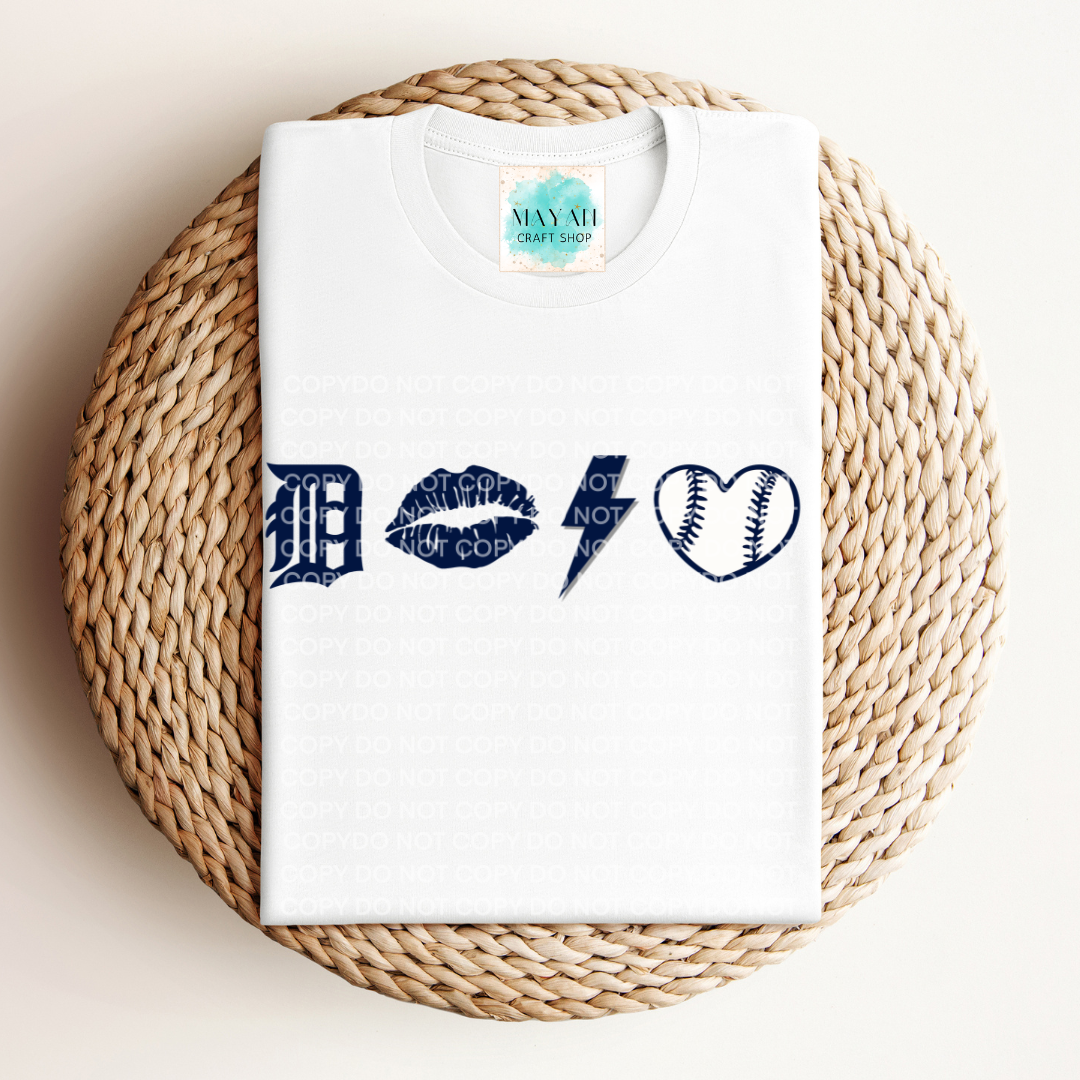 White t-shirt with blue graphic designs on a woven mat
