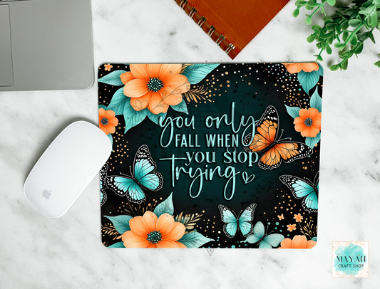 Mouse pad with floral and butterfly design on a marble surface