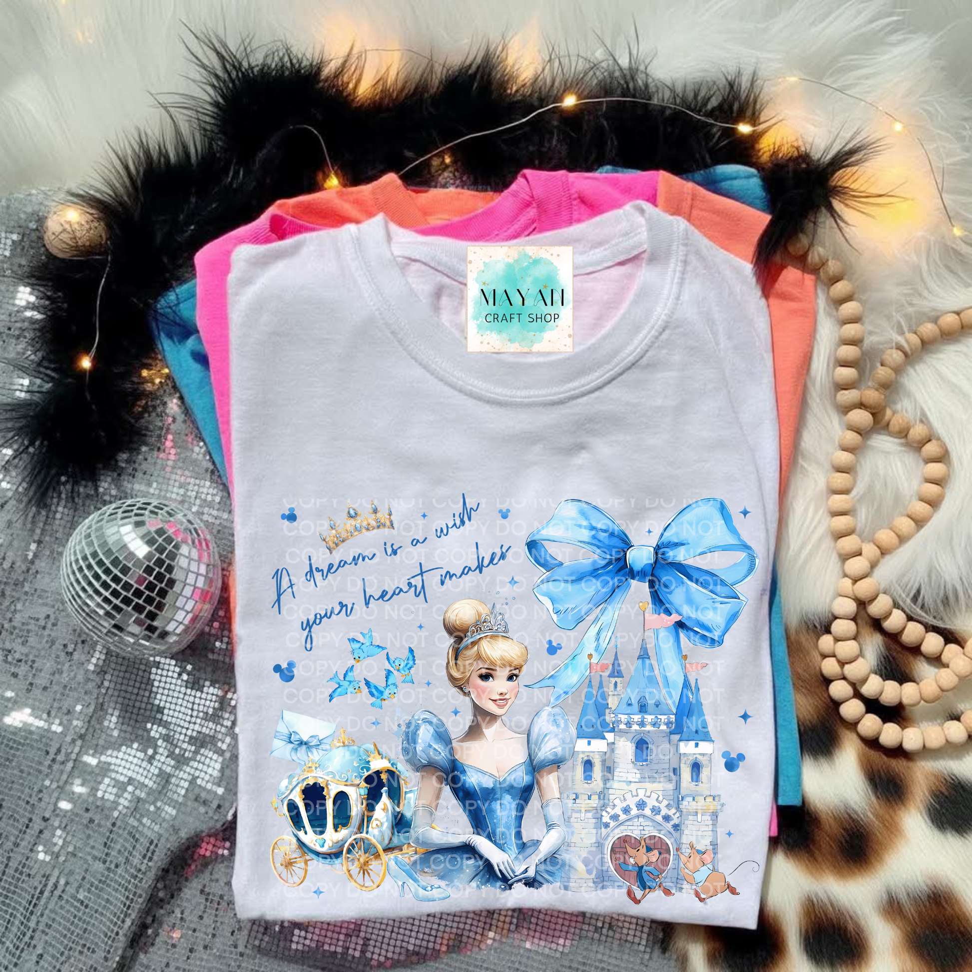 Princess-themed shirt with decorative elements on a textured surface.
