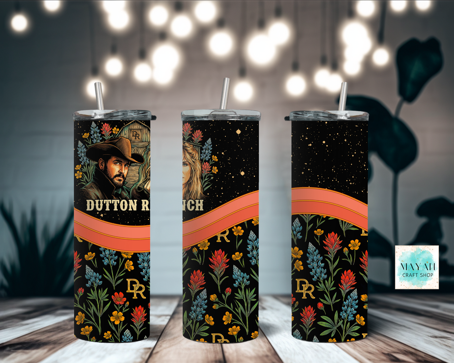 Three tumblers with floral designs and tv show branding on a wooden surface.