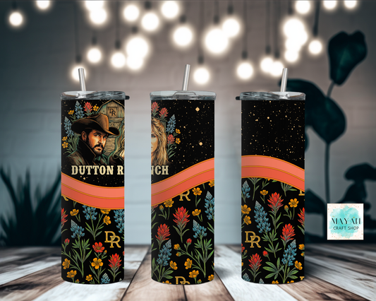 Three tumblers with floral designs and tv show branding on a wooden surface.