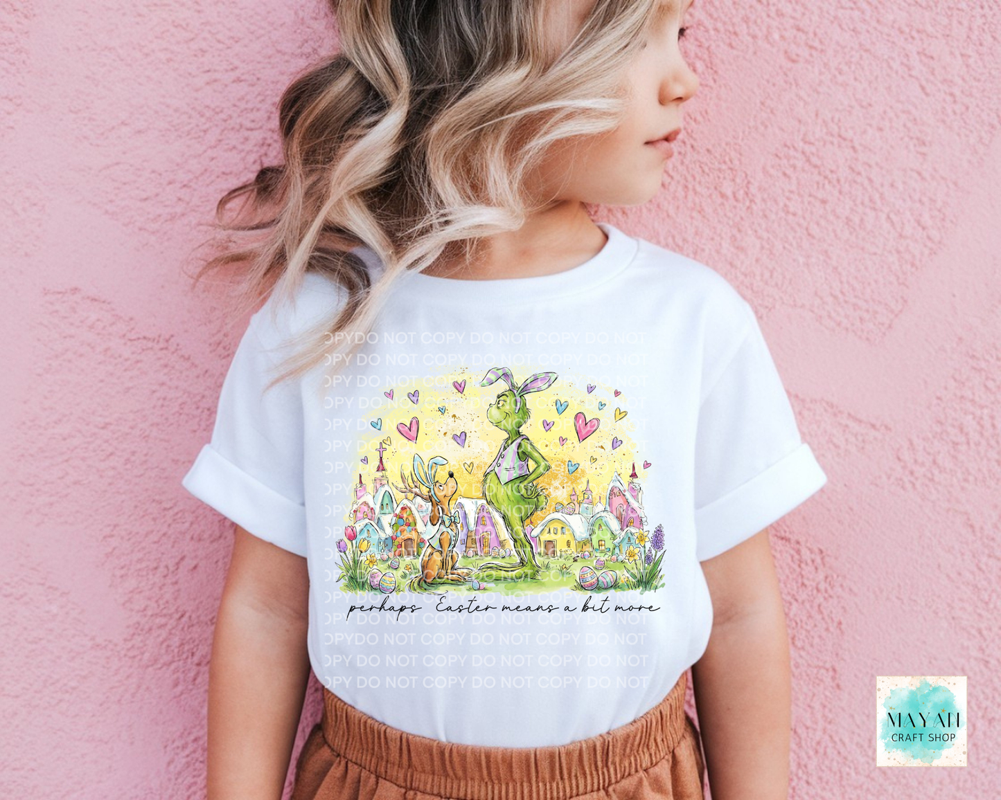 Child wearing a white t-shirt with a colorful graphic design against a pink background