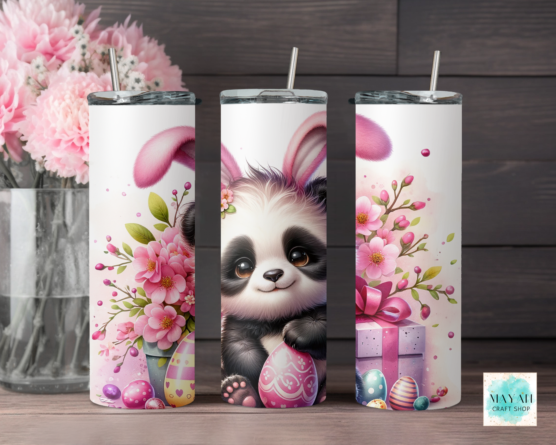 Three tumbler designs featuring a panda bear with pink flowers and Easter eggs on a wooden surface.