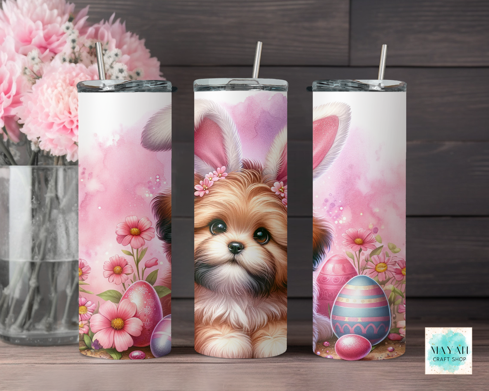 Three tumbler designs with a dog wearing bunny ears, flowers, and Easter eggs on a wooden surface.