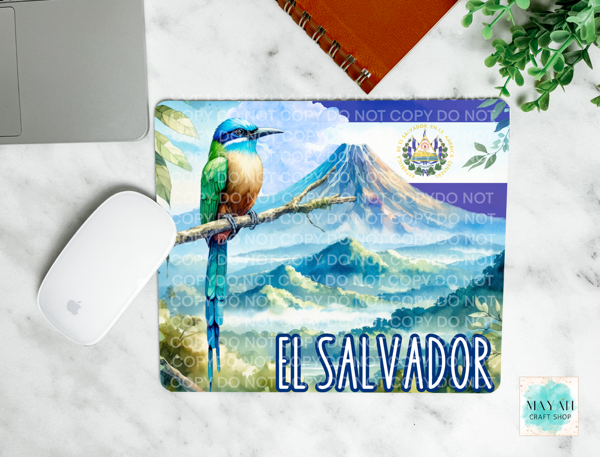 Mouse pad with a bird design and 'El Salvador' text on a marble surface.