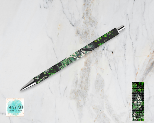 A marbled pen with green and black swirls, displayed diagonally on a white marble background. A color swatch is shown in the bottom-right corner.