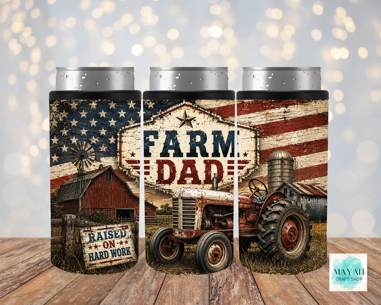 Three can coolers with farm-themed design featuring a tractor, barn, and American flag on a wooden surface.