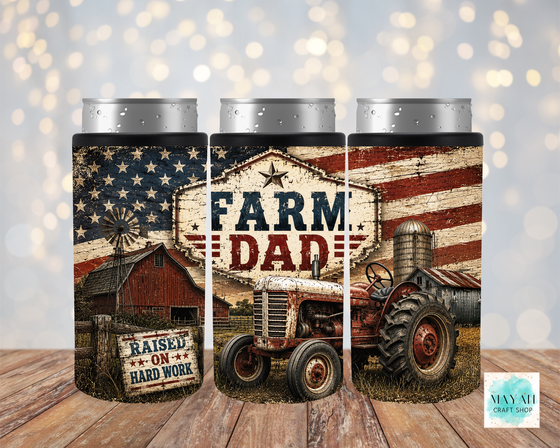 Three can coolers with farm-themed design featuring a tractor, barn, and American flag on a wooden surface.