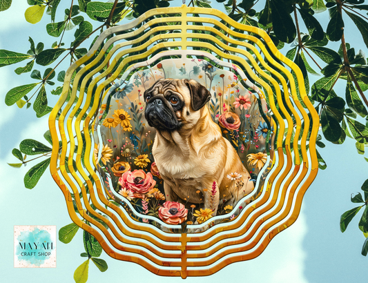 Pug dog surrounded by flowers and leaves in a decorative wind spinner