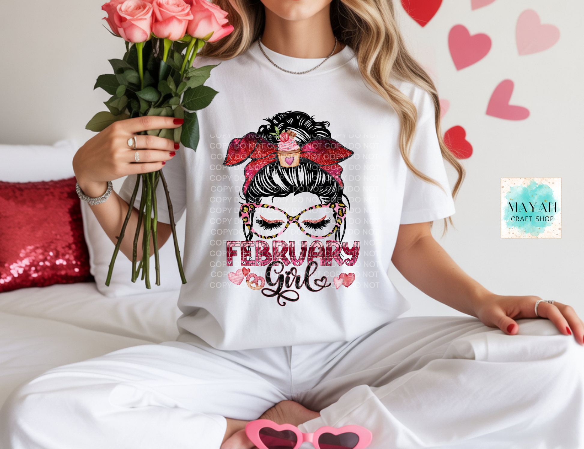 Person wearing a white t-shirt with 'February Girl' design, holding flowers and pink sunglasses.