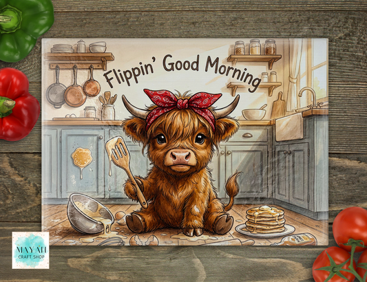 Cartoon cow with a bandana in a kitchen holding a spatula, with 'Flippin' Good Morning' text.