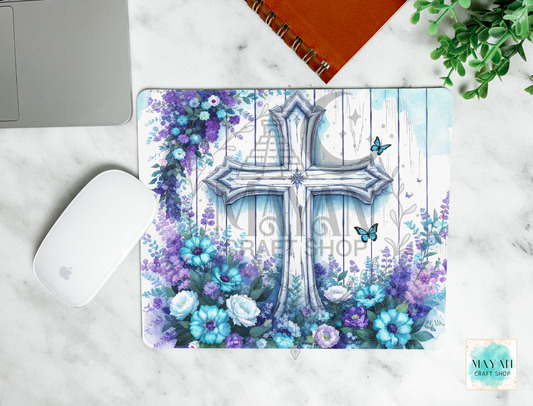 Mouse pad with a cross and floral design on a marble surface