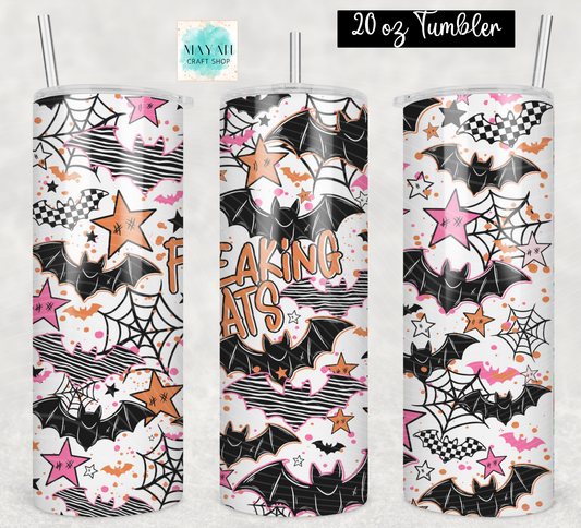 Three 20 oz tumblers with clear straws, featuring a Halloween-themed print with bats, spiderwebs, stars, clouds, and the words 'FREAKING BATS' in orange. The background is a light textured gray.