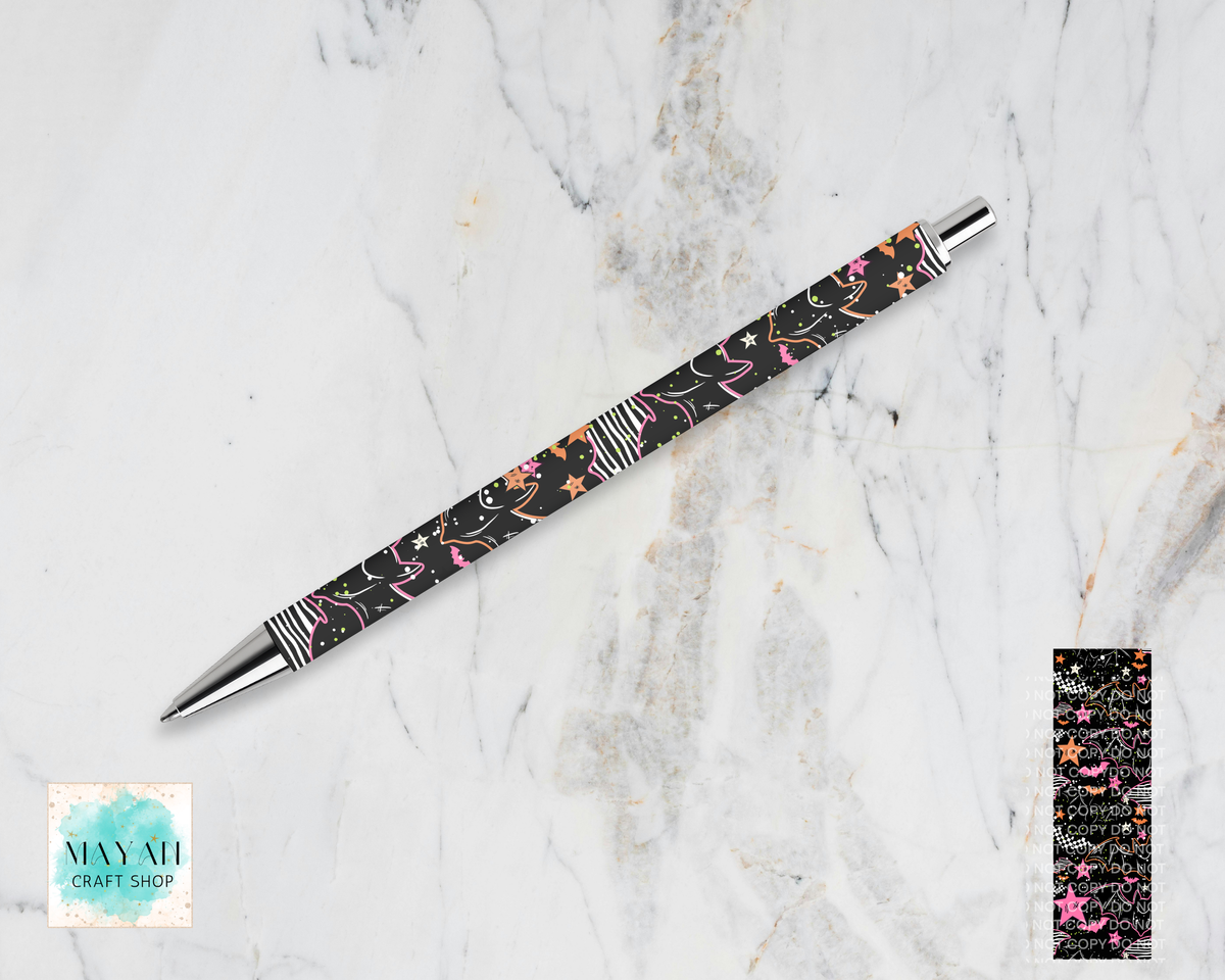 A ballpoint pen with a black barrel featuring a pink, orange, and white floral pattern, silver metal accents, and striped end caps, displayed diagonally on a white marble background.
